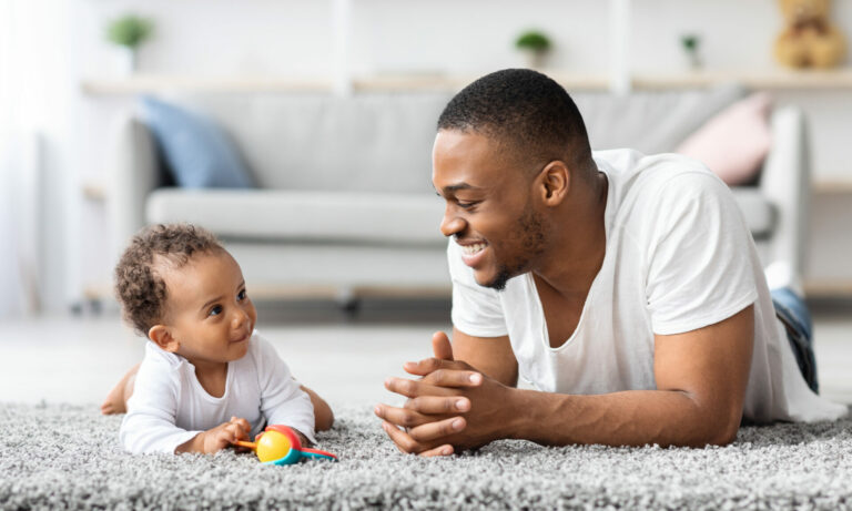 Father Baby Connection. Happy Black Man Bonding With Infant Child At Home