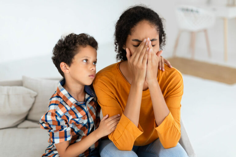 Boy showing concern and offering support to upset mommy